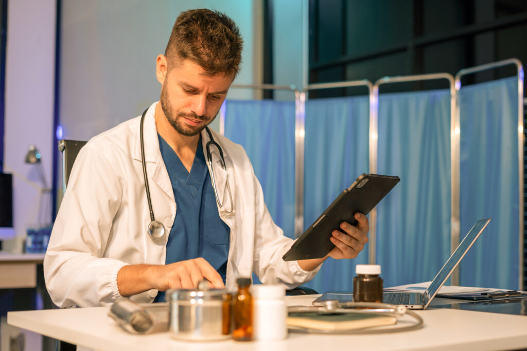 Medicine doctor hand working with modern digital tablet and laptop computer interface as medical network concept.